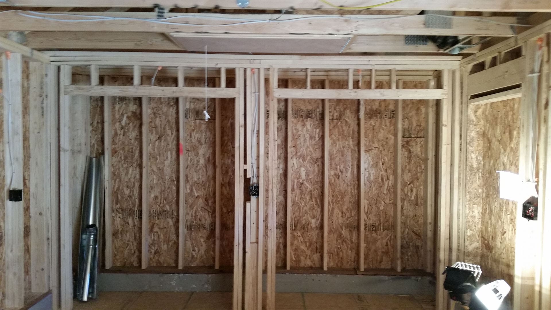 Framed interior openings and ceiling joists in a Denver home addition before drywall