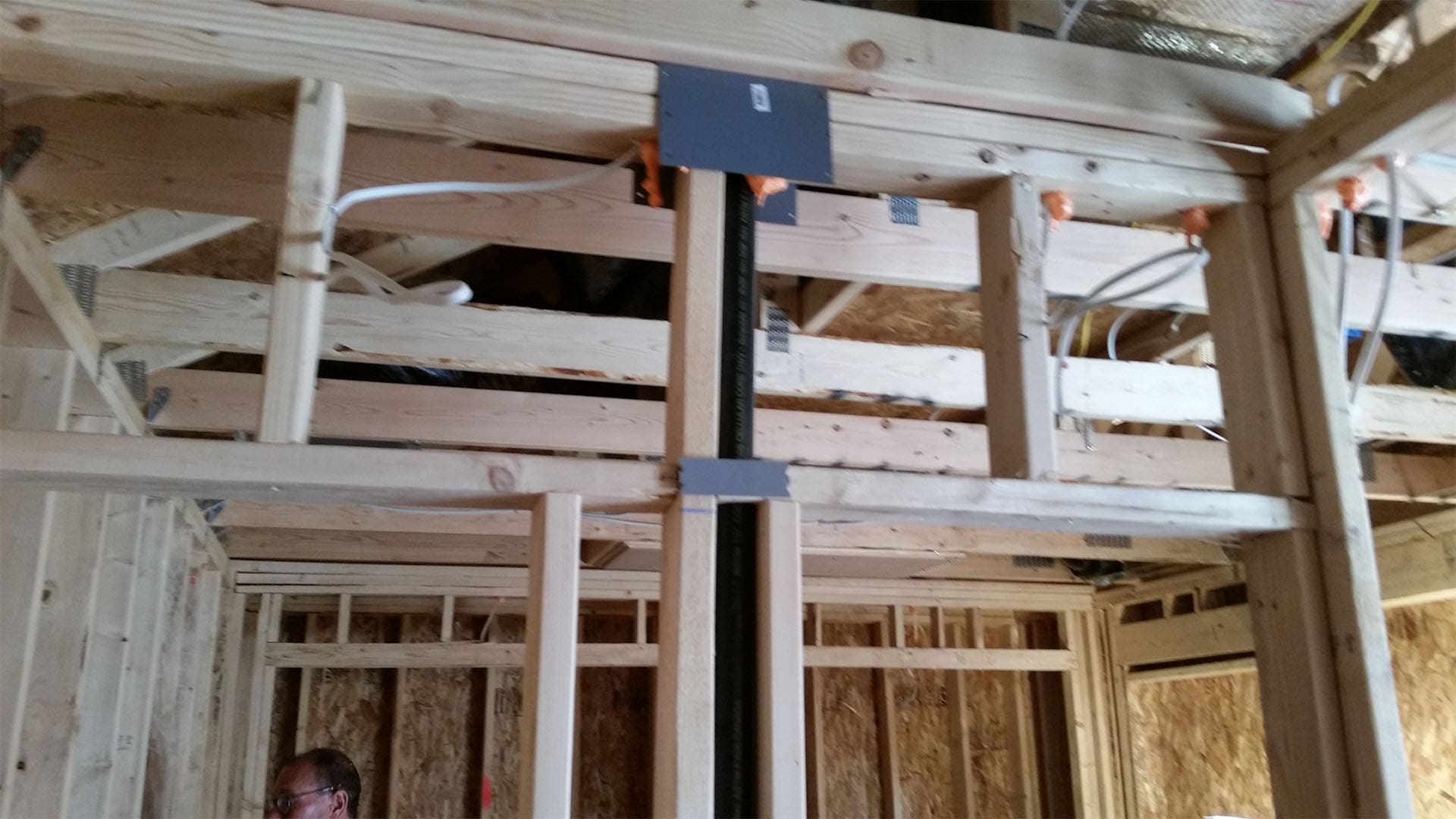 Engineered beam and post carrying the load over an open span in a Denver home addition