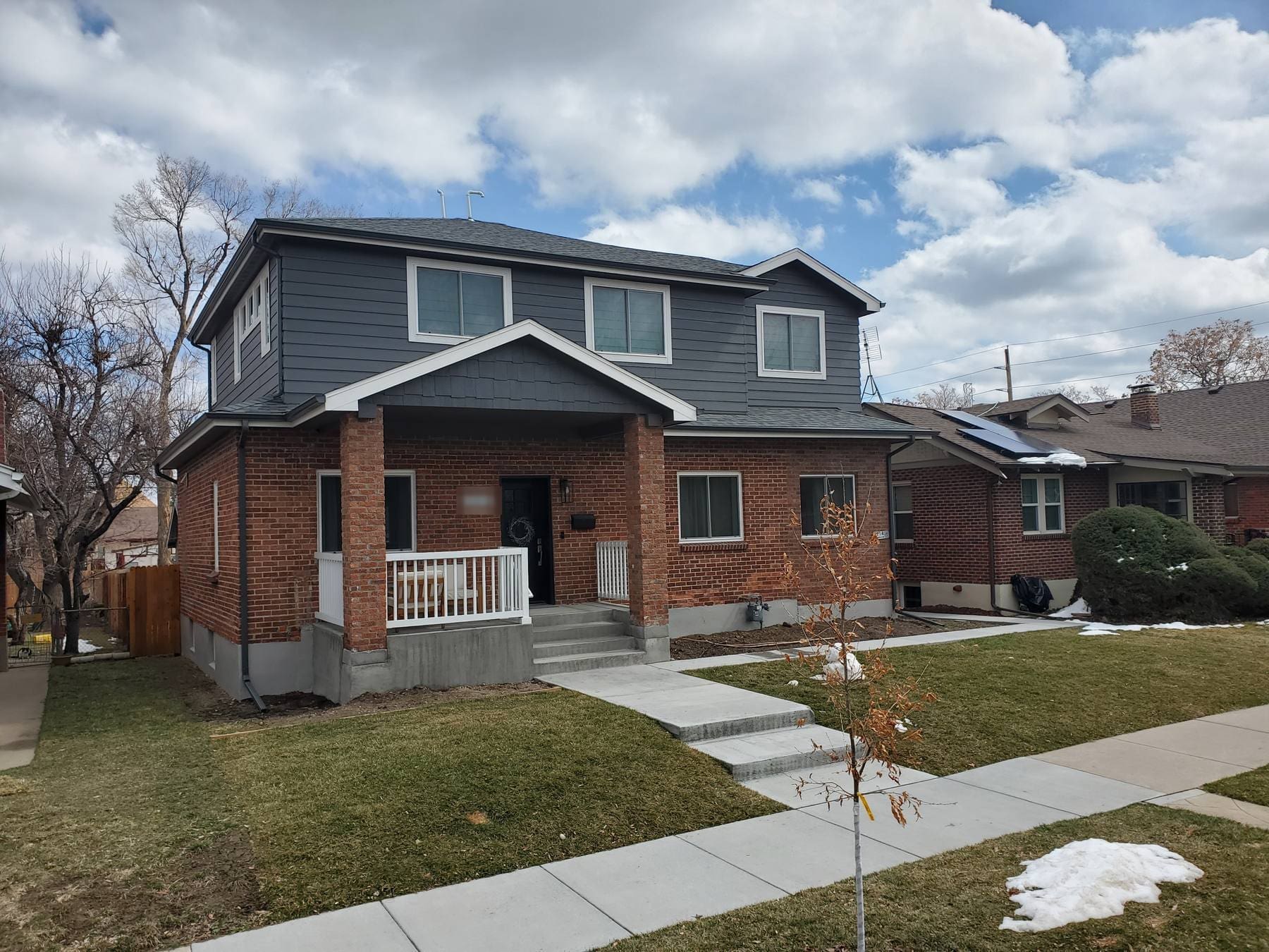 Denver brick bungalow after a full second-storey pop-top addition, with the original red brick ground floor retained